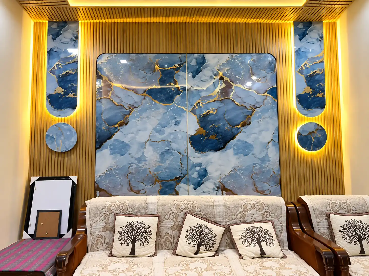 Blue marble-effect feature wall framed by warm wood fluted panels