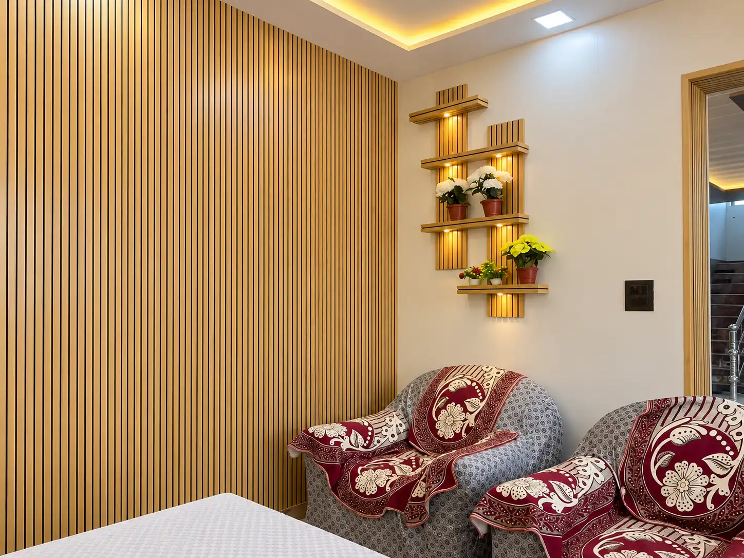 Warm wood fluted wall with illuminated display shelves in a sitting room