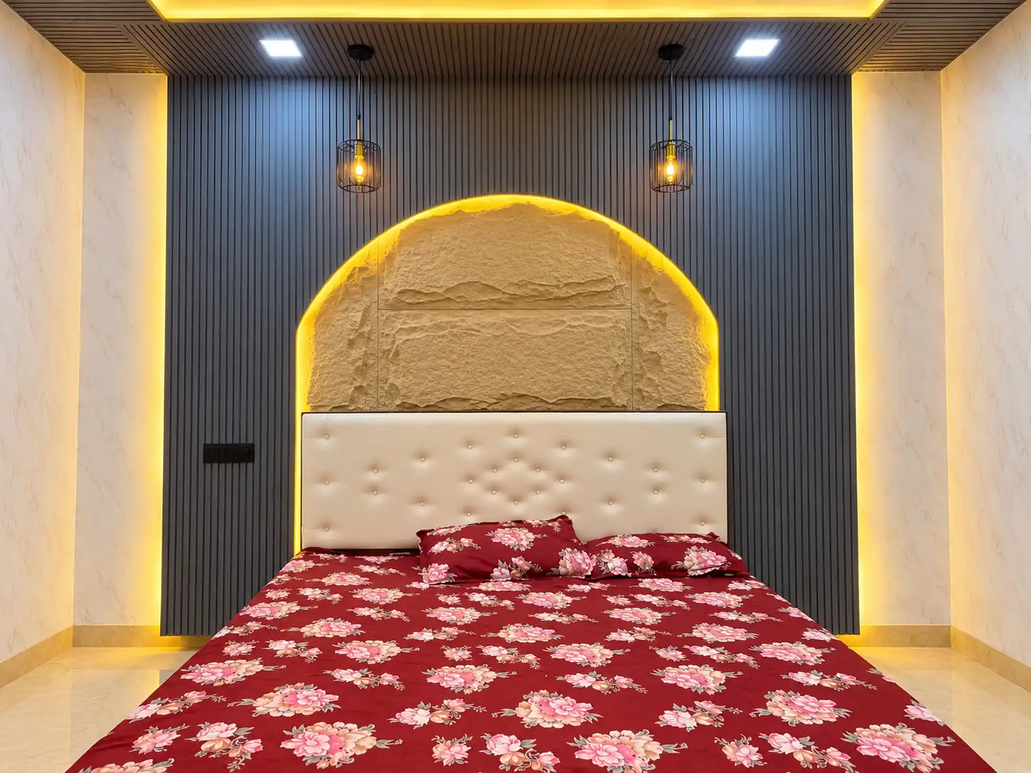 Dark fluted bedroom feature wall with an illuminated arched centre panel