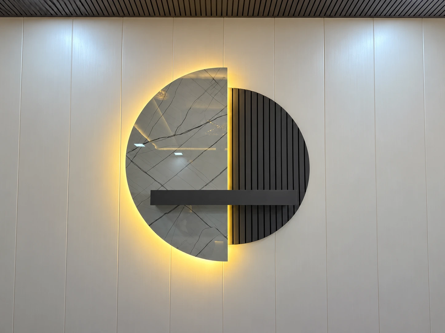 Decorative feature wall with marble-effect panel and fluted design
