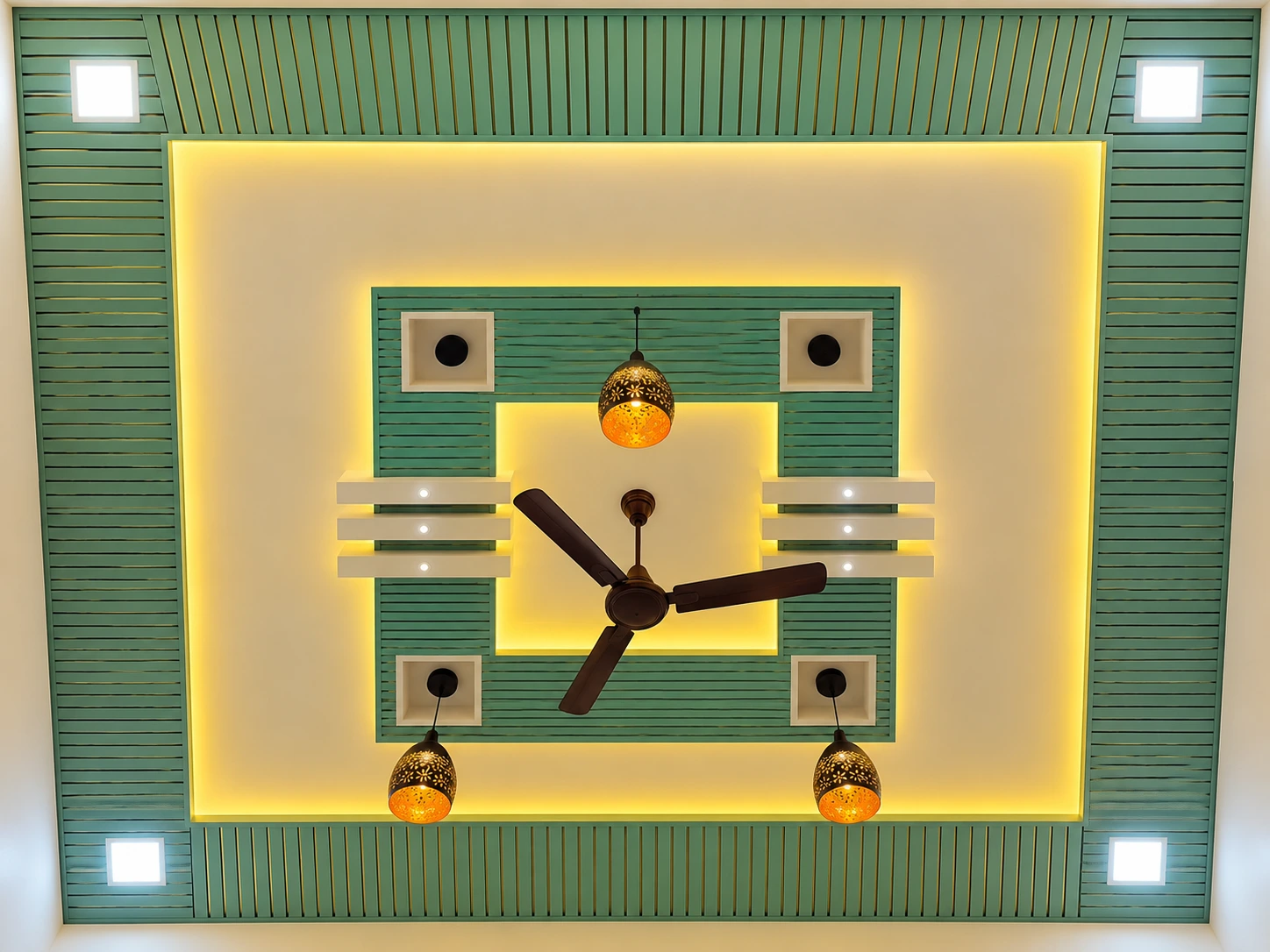 Green fluted PVC down ceiling with central lighting and a fan